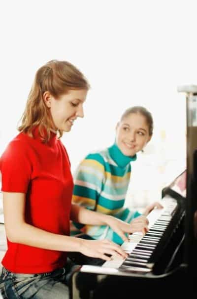 girl taking piano lessons