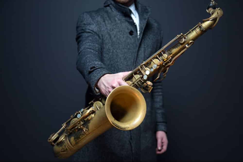 saxophone teacher holding saxophone